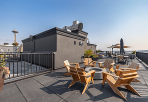 Seattle apartment for rent - A rooftop patio with wooden chairs and a table.