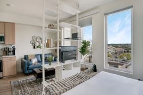 Seattle apartment for rent - a bedroom with a bed and a large window