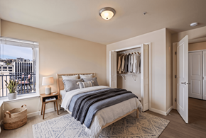 Seattle apartment for rent - A bedroom with a large bed and a view of the city.