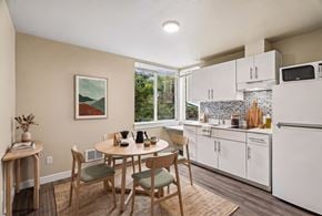 Seattle apartment for rent - A kitchen with a table and chairs in the middle of the room.