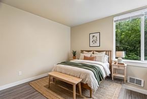 Seattle apartment for rent - A bedroom with a bed, nightstand, and window.