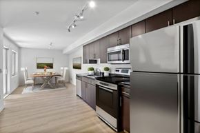 Seattle apartment for rent - kitchen and dining room with stainless steel appliances and a table