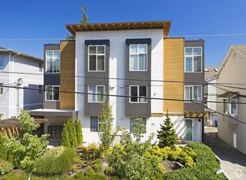 Seattle apartment for rent - an apartment building with a yard in front of it
