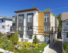 Seattle apartment for rent - a row of apartments with balconies and a yard