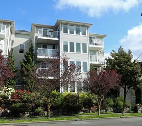Seattle apartment for rent - Apartment building with trees in front of it.