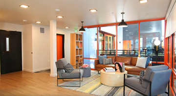 Seattle apartment for rent - A living room with a grey chair and a brown couch.