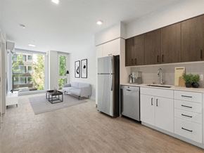 Seattle apartment for rent - a kitchen and living room with a refrigerator