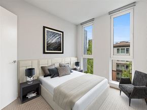 Seattle apartment for rent - a bedroom with a bed and a large window