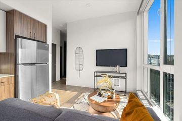 Seattle apartment for rent - A modern living room with a grey sofa and a wooden coffee table.