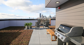 Seattle apartment for rent - A BBQ grill is on a patio with a view of the city.