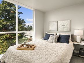 Seattle apartment for rent - a bedroom with a bed and a large window