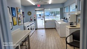 Orange City apartment for rent - A view of a laundromat with washers and dryers.