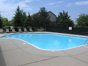 Lapeer apartment for rent - Heated Pool, with plenty of lounge chair sunning, umbrella tables, and shower locker rooms and private restrooms. The Playground and picnic area is located just outside the pool area.
