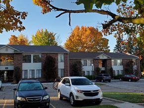 Lapeer apartment for rent - an apartment building with cars parked in front of it