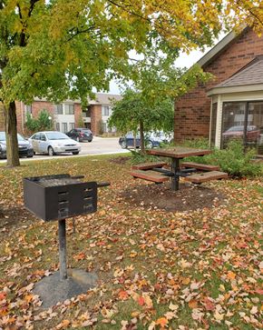 Lapeer apartment for rent - a picnic table and a grill in front of a house