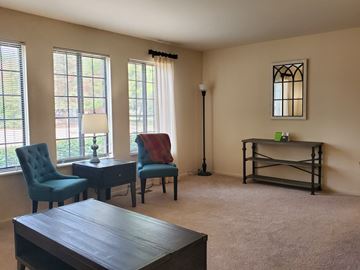 Imlay City apartment for rent - a living room with a table and chairs and windows