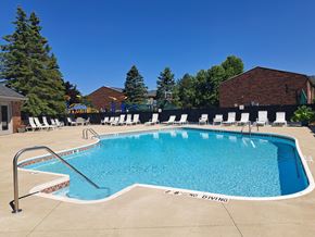 Imlay City apartment for rent - a swimming pool at a resort with chairs around it