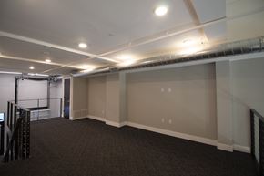 Lincoln apartment for rent - a room with a carpeted floor and a projector screen on the wall