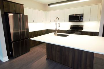 Lincoln apartment for rent - a kitchen with a white counter top and a stainless steel refrigerator