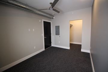 Lincoln apartment for rent - a living room with a carpet and a door to a hallway