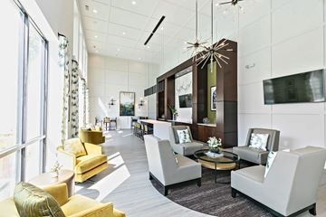 Atlanta apartment for rent - A modern living room with a yellow sofa and a glass chandelier.
