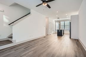 Atlanta townhouse for rent - A spacious room with a ceiling fan and wooden flooring.
