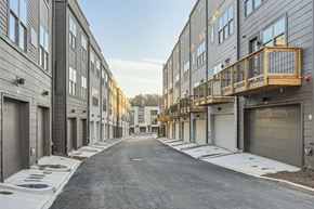 Atlanta townhouse for rent - A long, narrow street with buildings on either side and a clear sky above.