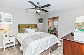 Atlanta apartment for rent - A bedroom with a large bed and a ceiling fan.