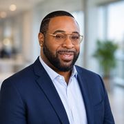 Charlotte apartment for rent - A man with glasses and a beard is wearing a blue suit.