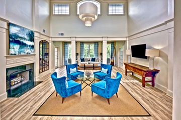 Atlanta apartment for rent - A living room with blue chairs and a fireplace.
