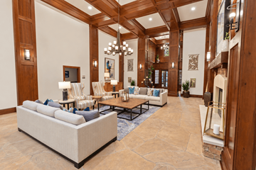 Charlotte apartment for rent - A spacious living room with a large sofa and a fireplace.