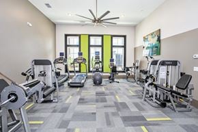 Dunwoody apartment for rent - A gym with a variety of equipment including treadmills, weights, and exercise machines.
