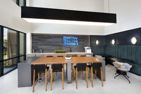 Oviedo apartment for rent - a large table and chairs in a room with a large screen tv on the wall