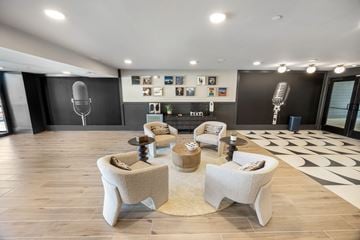 Duluth townhouse for rent - A modern living room with a black and white patterned rug and a wooden floor.