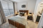 Duluth townhouse for rent - A bedroom with a large bed and a picture of a camera on the wall.