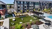 Duluth townhouse for rent - A large outdoor swimming pool area with a grassy area and a pavilion.