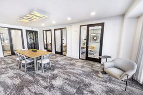 Duluth townhouse for rent - A modern dining room with a wooden table and grey chairs.