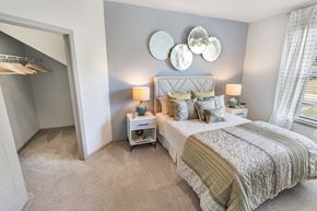Mt Juliet apartment for rent - A bedroom with a large bed and a small nightstand with a lamp.