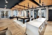 Dacula townhouse for rent - A modern office space with a long white table and wooden floors.