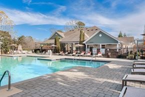 Mooresville apartment for rent - A large swimming pool with a house in the background at Echo at Lake Norman, Mooresville