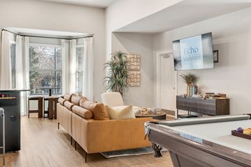 Mooresville apartment for rent - A living room with a pool table and a television displaying the word "Echo".