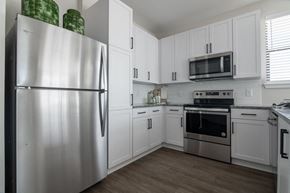 Grayson apartment for rent - a kitchen with stainless steel appliances and white cabinets