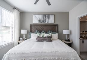 Grayson apartment for rent - a bedroom with a large bed and a ceiling fan