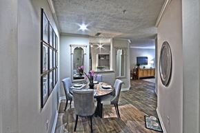 Atlanta apartment for rent - A dining room with a table set for two and a mirror on the wall.