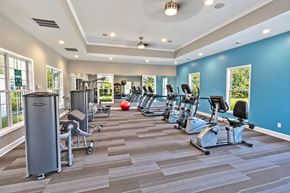 Grayson apartment for rent - A gym with a variety of equipment including treadmills, weights, and exercise machines.
