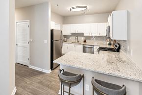 Grayson apartment for rent - A kitchen with a white counter top and a refrigerator.