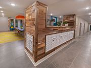 Charlotte apartment for rent - the lobby of a building with a wooden wall and drawers