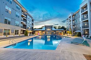 Charlotte apartment for rent - an apartment building with a swimming pool in front of it