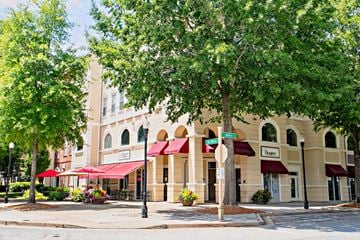 Alpharetta townhouse for rent - A building with a red awning and a sign that says "Terry's" is surrounded by trees.