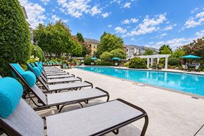 Alpharetta townhouse for rent - A pool with chairs around it.